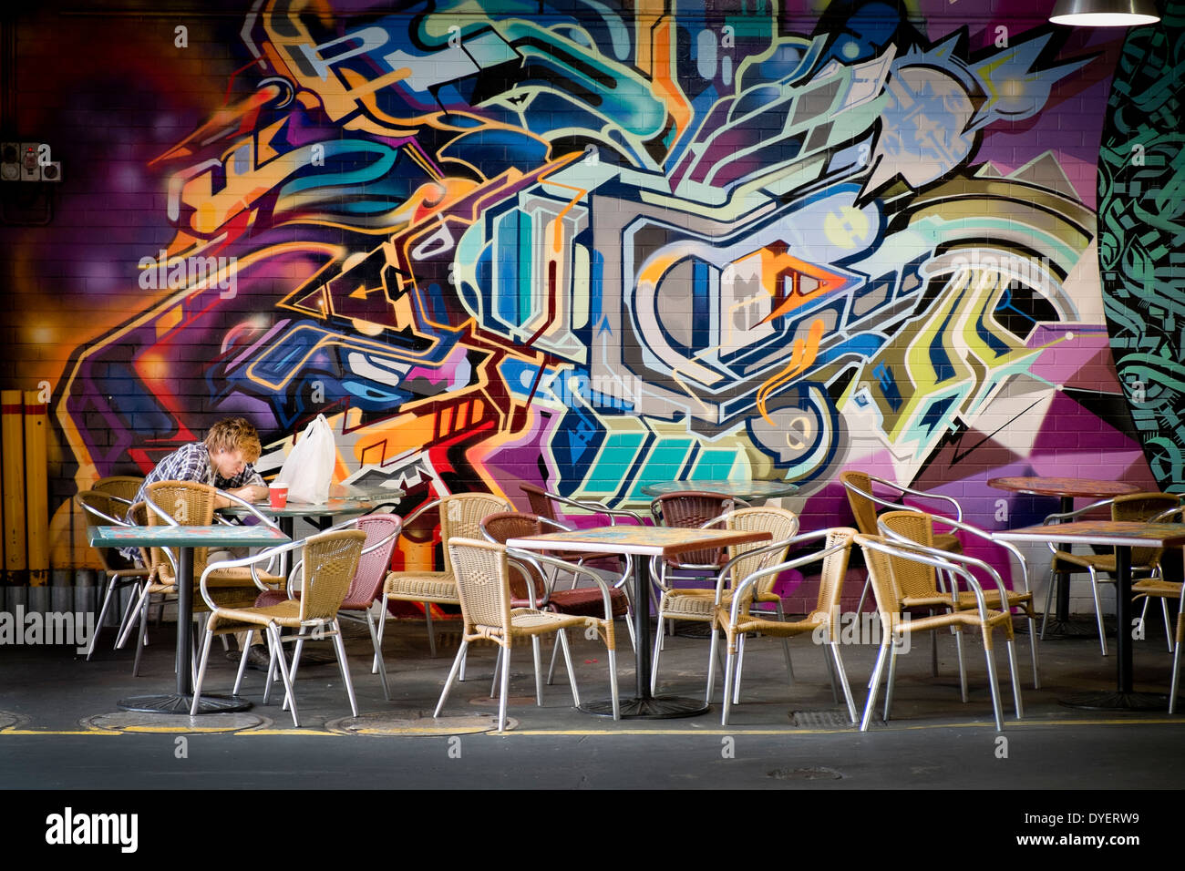 Un étudiant étranger dans un café décoré dans des arts de la rue Adelaide Central Market Banque D'Images