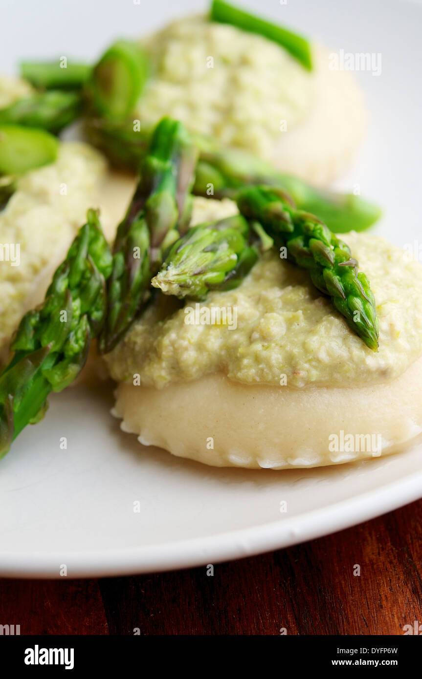 Raviolis fait maison avec ricotta vegan le remplissage et un pesto de noix asperges. Banque D'Images