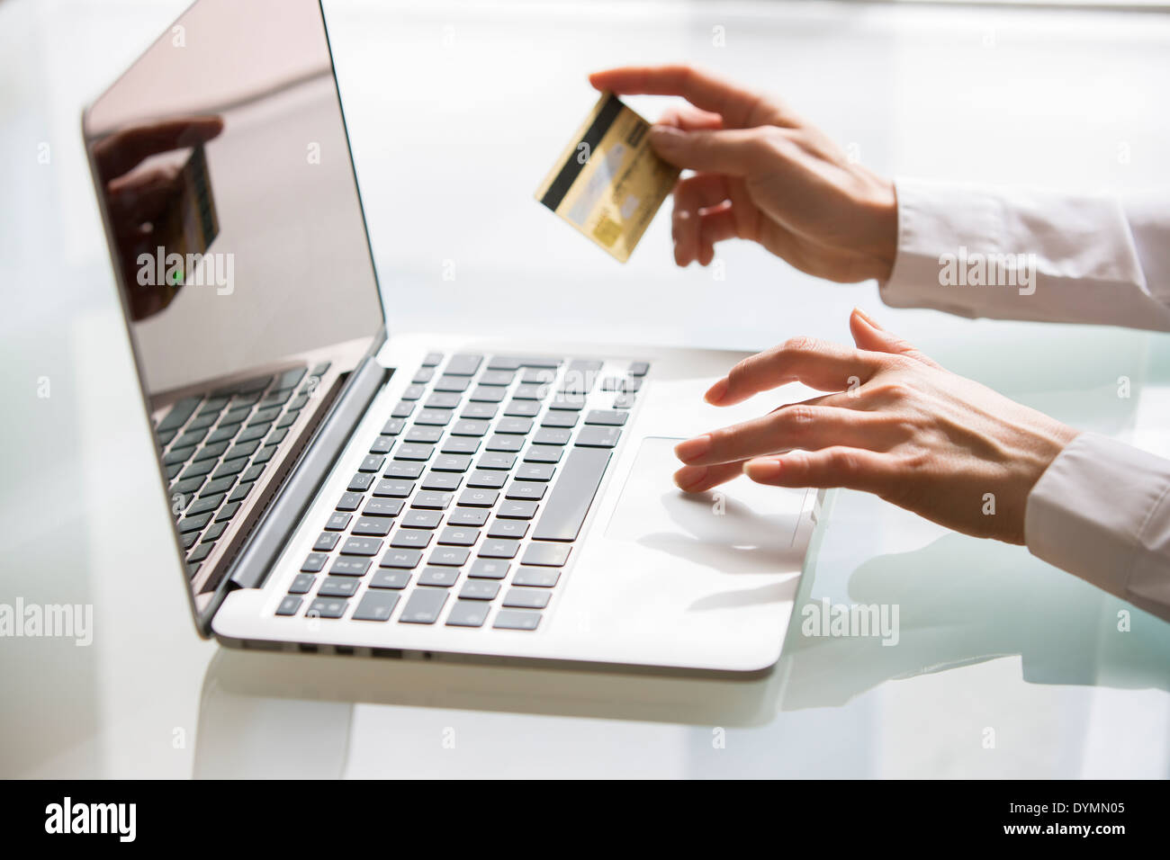 Woman shopping sur Internet avec ordinateur portable et une carte de crédit Banque D'Images