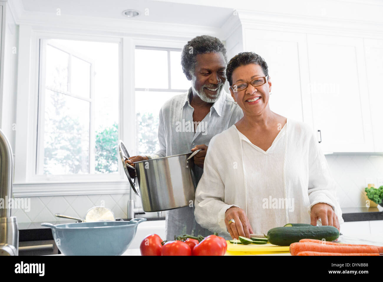 Senior couple cooking in kitchen Banque D'Images