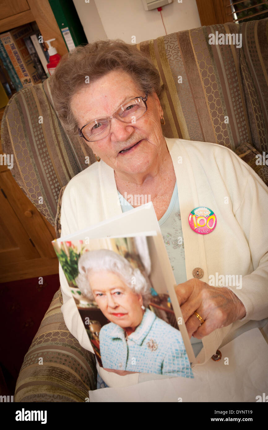 Femme âgée avec son 100e anniversaire carte de la Reine. Banque D'Images