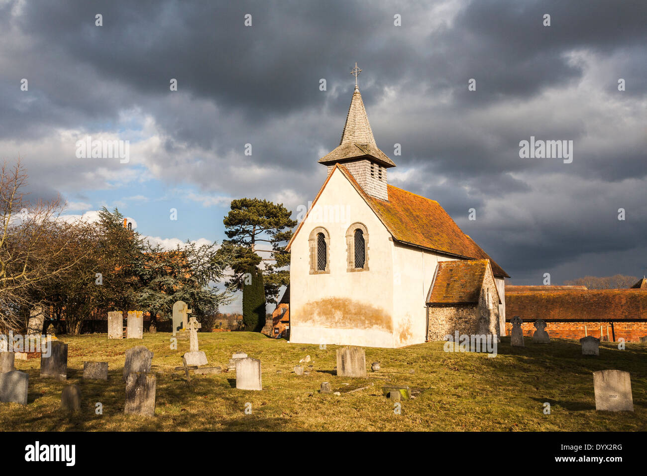 Norman/église médiévale à Wisley, Surrey, datant de 1150 avec le ciel et les nuages orageux Banque D'Images