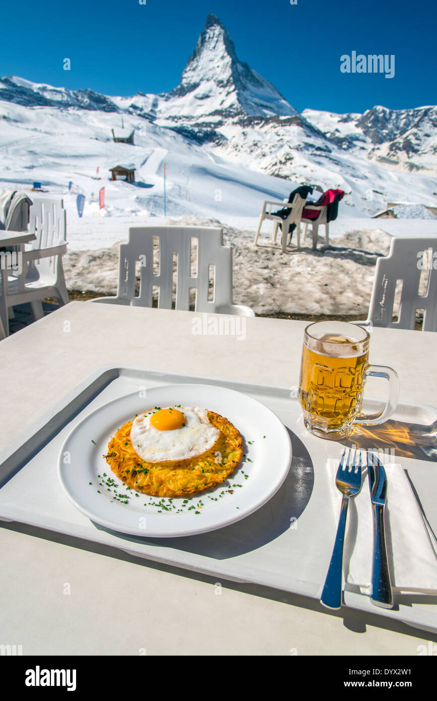 Rosti avec œuf frit, un plat traditionnel suisse, avec en arrière-plan le Mont Cervin, Zermatt, Valais ou Valais, Suisse Banque D'Images