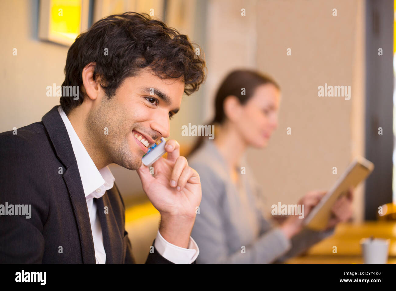 Joyeux mâle appelant restaurant cafe smartphone tablet pc femelle Banque D'Images