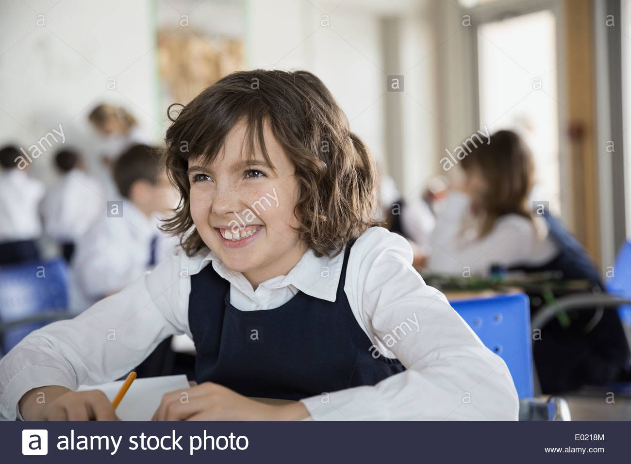 School girl Smiling in classroom Banque D'Images