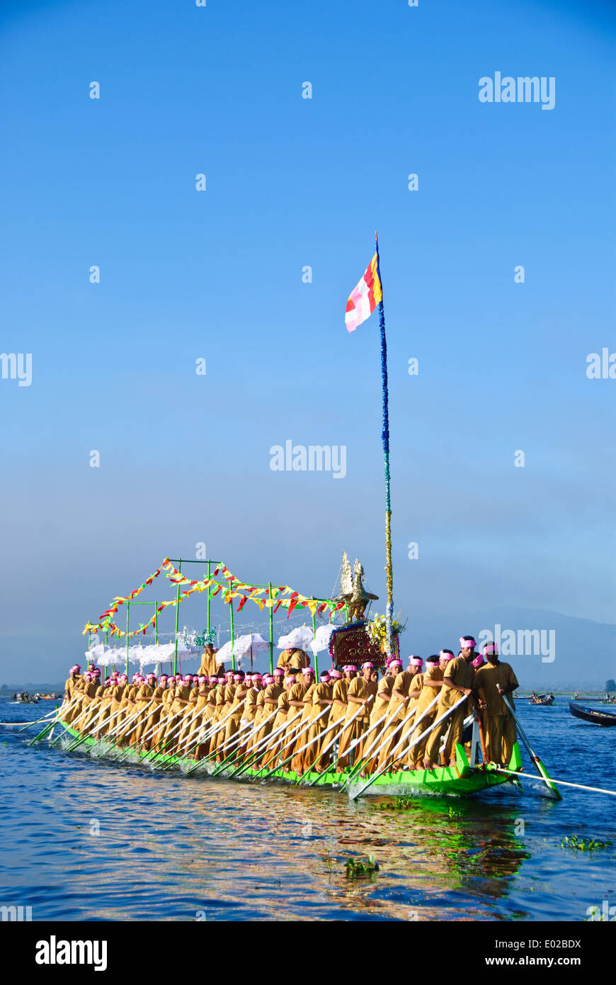 Leg-rameurs d'avancer en tirant sur la barge royale à travers le lac Inle pendant le festival Banque D'Images