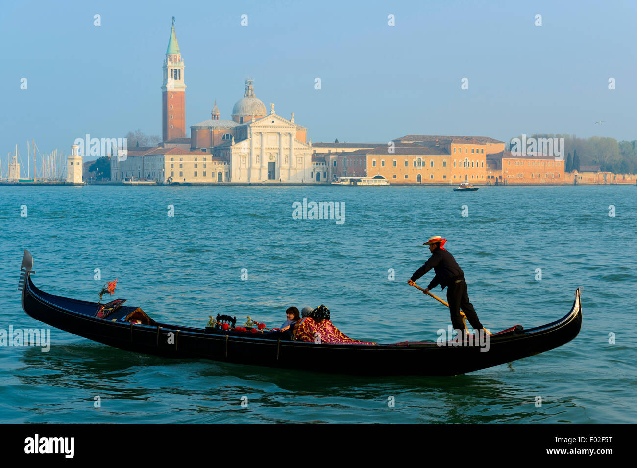 Gondolier onn le bassin San Marco, l'église de San Giorgio Maggiore à l'arrière, Venise, Vénétie, Italie Banque D'Images