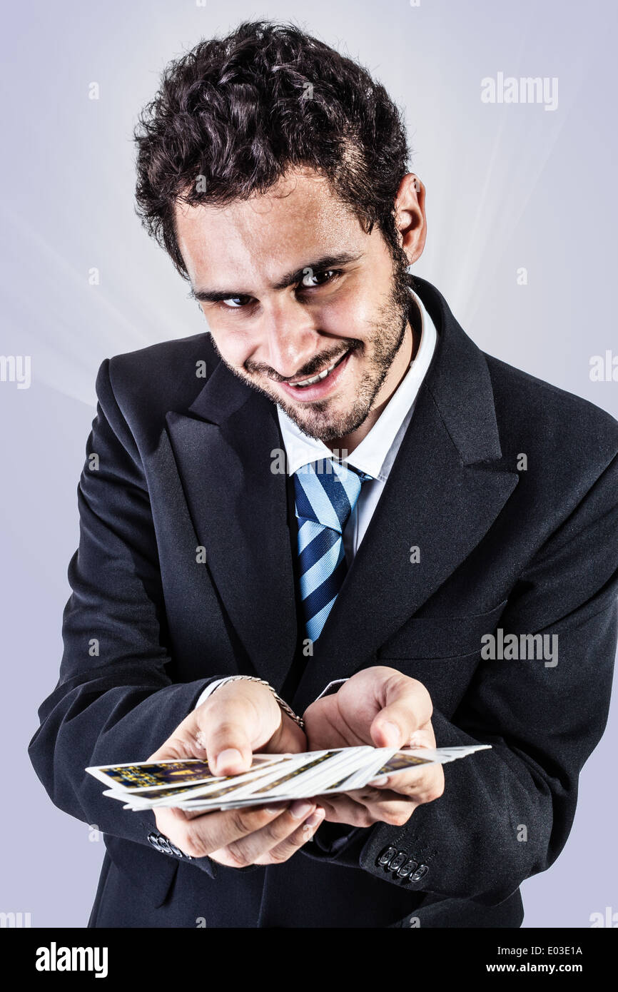 Un élégant jeune businessman holding a des jeux de cartes Banque D'Images