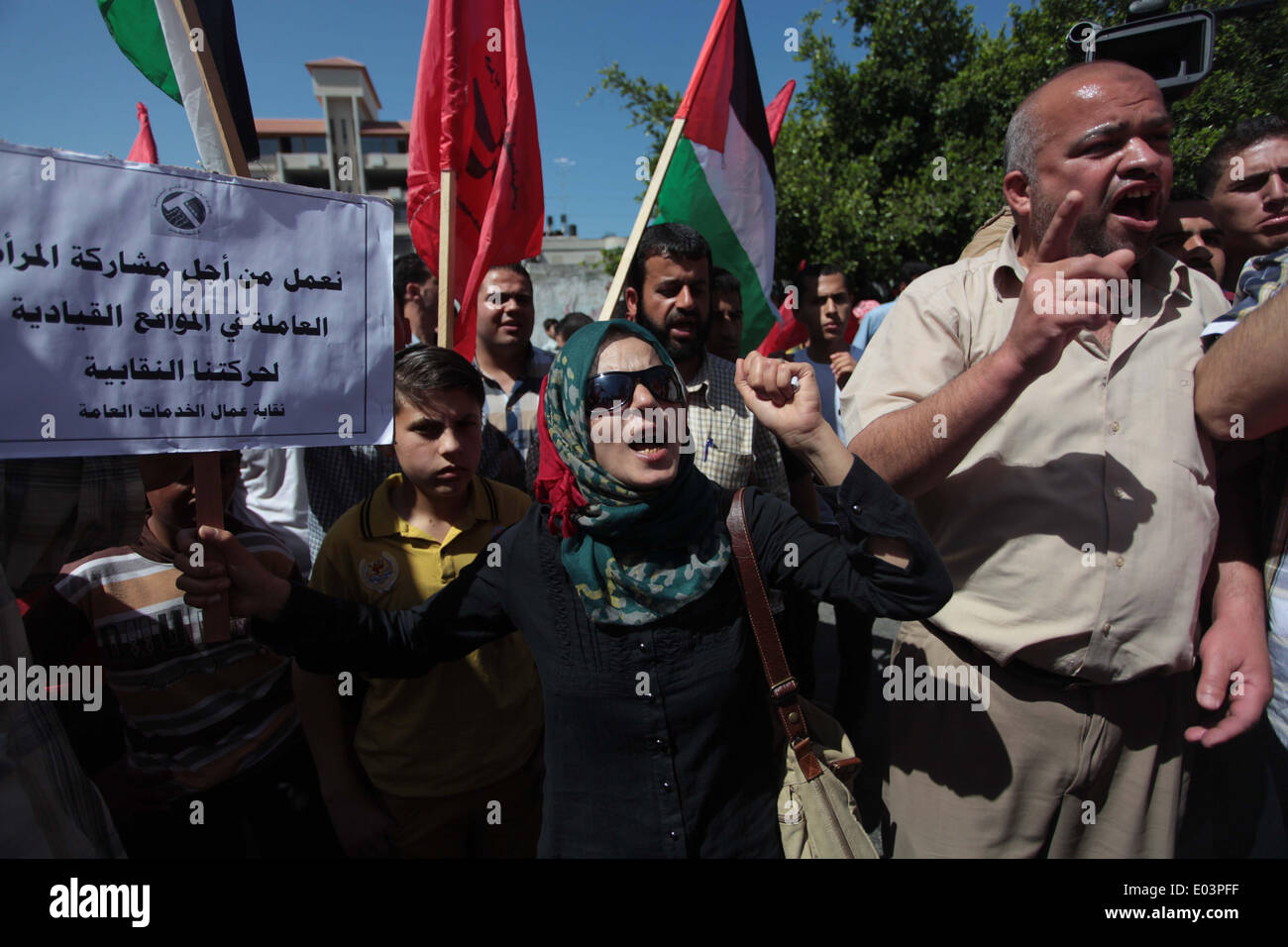 Gaza, la Palestine. 01 mai, 2014. Travaux palestinienne slogans chant comme d'autres l'attente lors d'un des bols mars pour la Journée internationale du travail dans la ville de Gaza, le Jeudi, Mai 1, 2014. L'arabe se lit, ''Le bol de la faim, la pauvreté et la famine, où est la conscience, '' Selon le Bureau des Nations Unies pour la coordination des affaires humanitaires, le taux de chômage dans la bande de Gaza est l'un des plus élevés au monde. Credit : ZUMA Press, Inc./Alamy Live News Banque D'Images