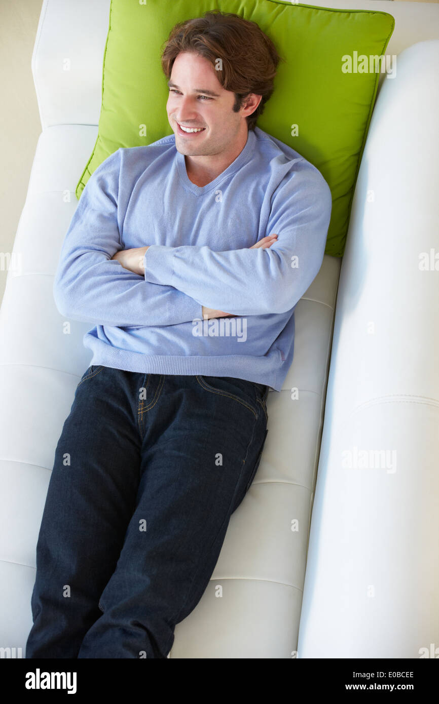Vue aérienne de Man Relaxing On Sofa Banque D'Images Vue aérienne de Man Relaxing On Sofa Banque D'Images