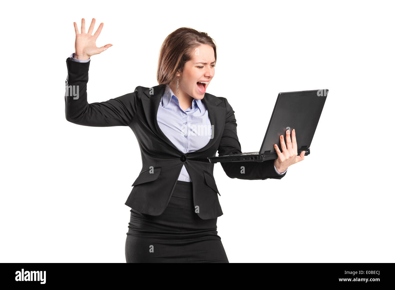 Furious businesswoman yelling at a laptop Banque D'Images