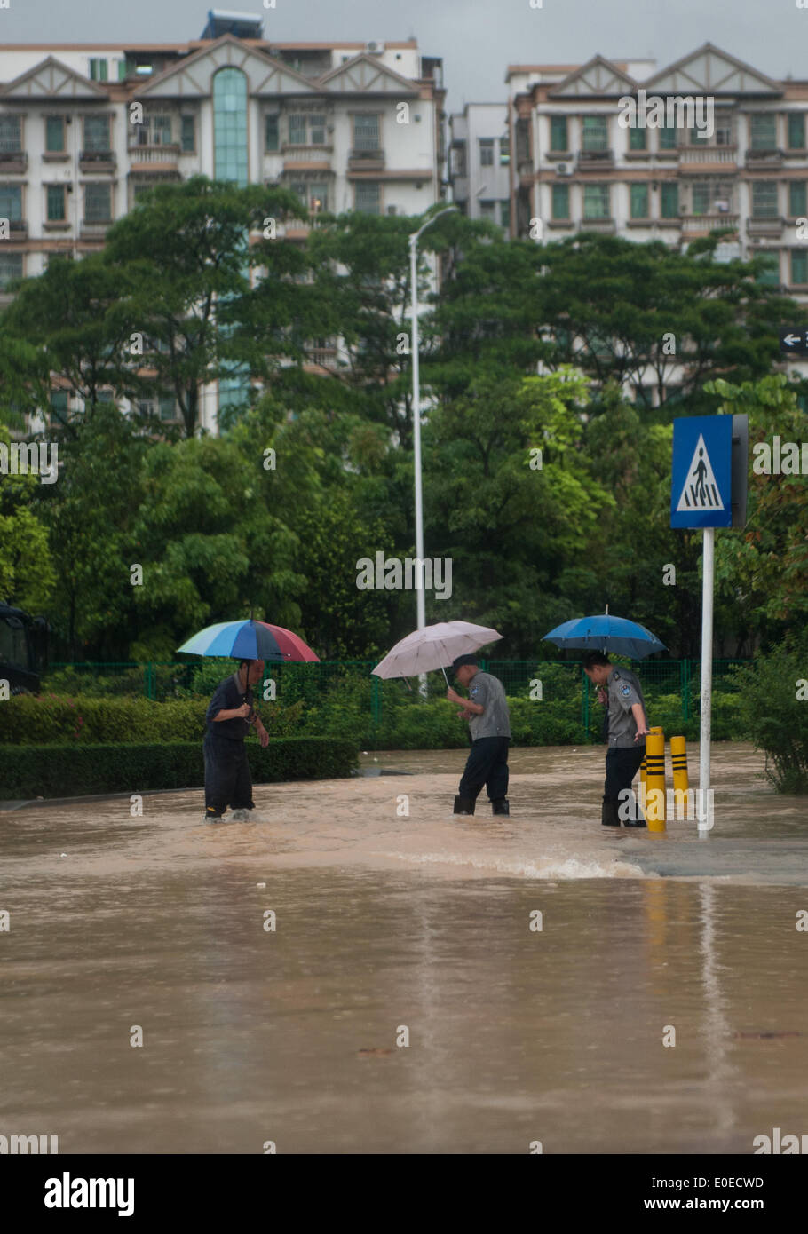 Shenzhen, la province chinoise du Guangdong. Le 11 mai, 2014. Les gens marchent dans les inondations dans les rues de Shenzhen, province du Guangdong en Chine du sud, le 11 mai 2014. Un violent orage a frappé la ville le dimanche. Le bureau météorologique local a publié l'alerte rouge pour les orages. Credit : Mao Siqian/Xinhua/Alamy Live News Banque D'Images
