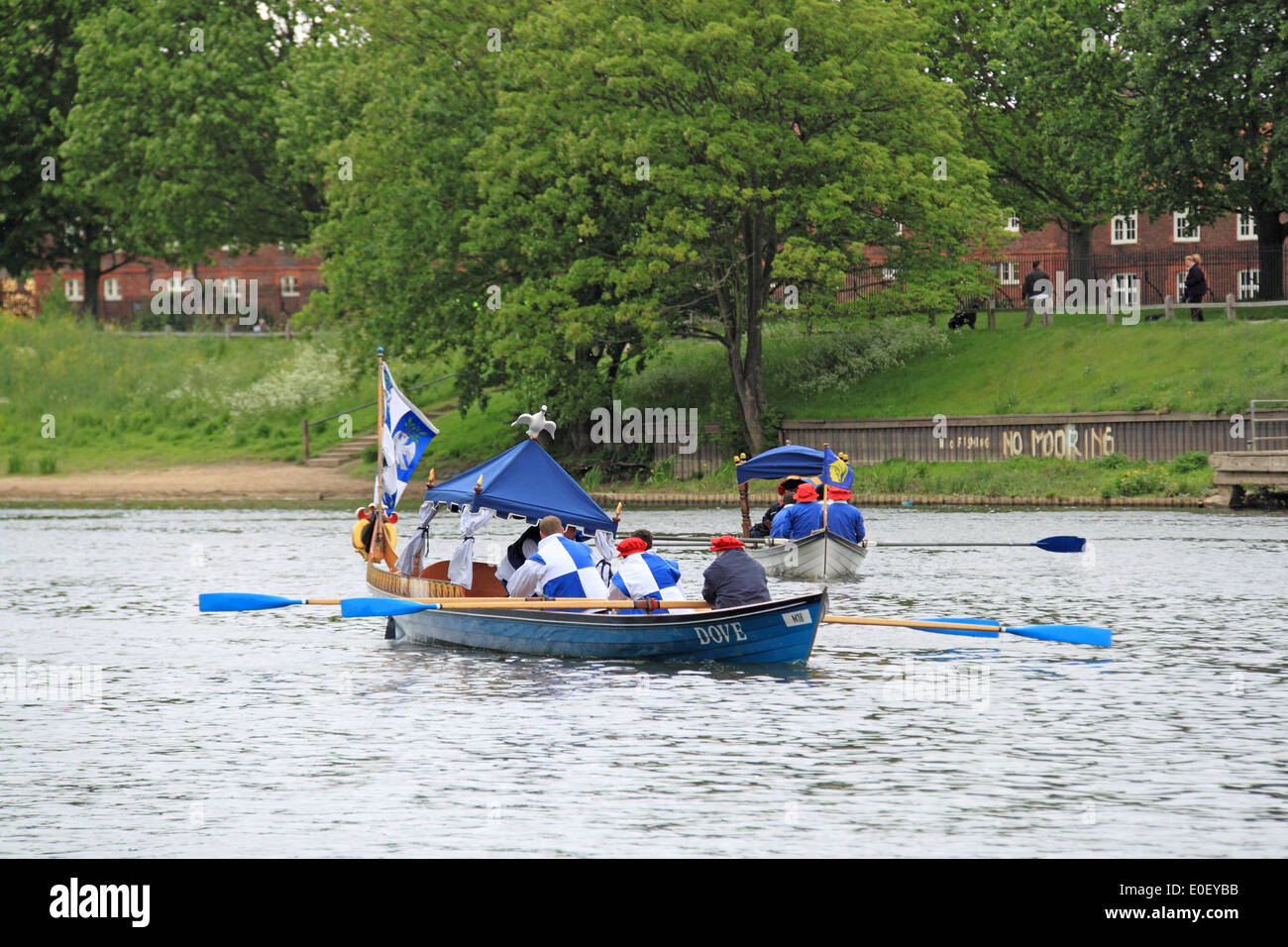 Tirez Tudor. Le Palais de Hampton Court, East Molesey, Surrey, UK. Le 11 mai, 2014. Annuelles traditionnelles d'aviron entre l'historique Royal Palais de Hampton Court et de la Tour de Londres. Coupe-Thames, ici d'un équipage de la Thames Rowing Association traditionnelle, l'escorte Barge Royale Gloriana tandis qu'elle livre un "tela" pour le gouverneur de la tour. Ce "tela" est un morceau de l'ancienne conduite d'eau, fabriqué à partir d'un tronc d'arbre creux qui se tient sur une base de bois provenant de l'ancienne écluse de Richmond et porte le blason de la Worshipful Company of mariniers et Aconiers. Banque D'Images