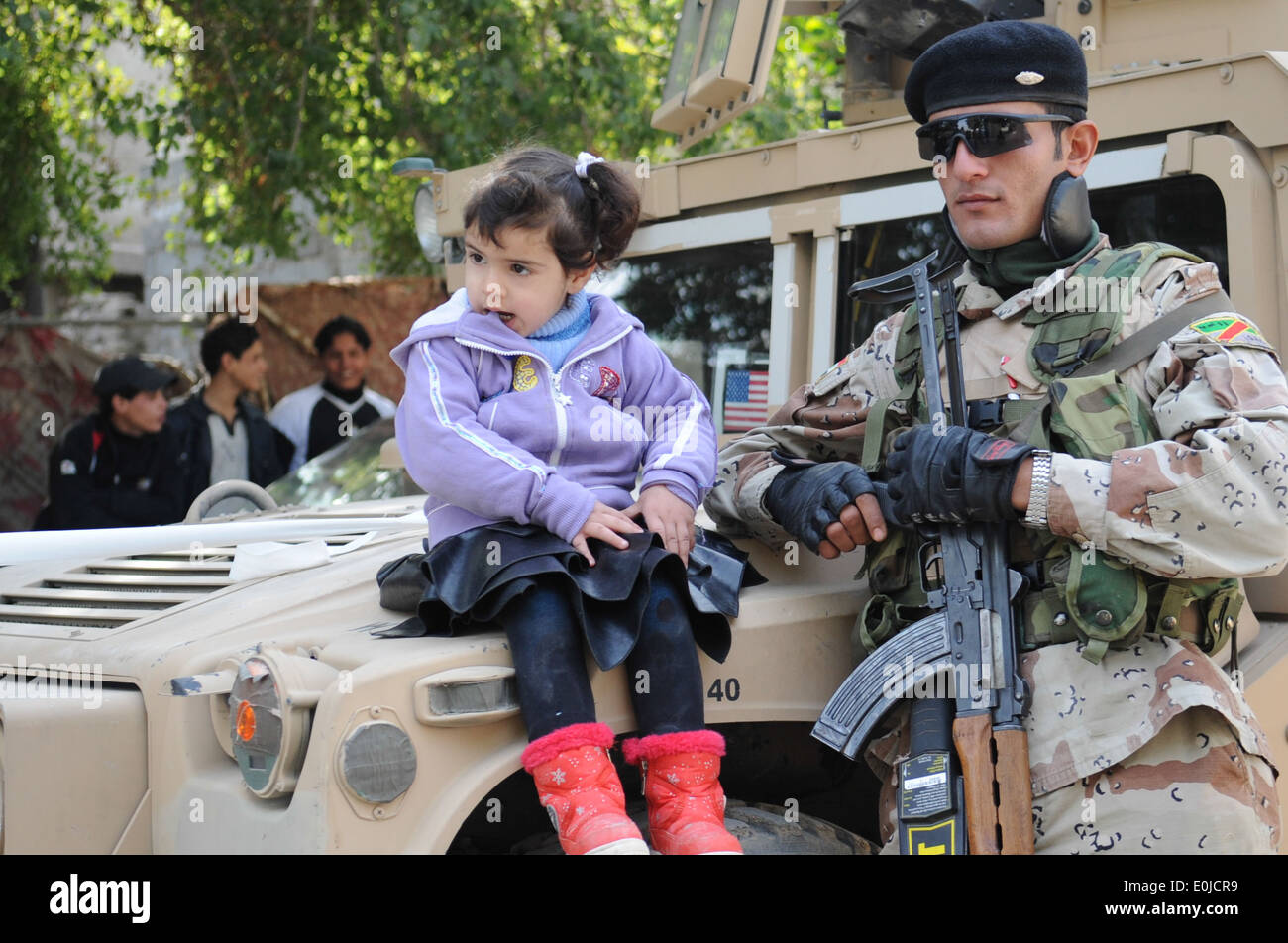 Une jeune fille iraquienne est assis sur le capot d'un Humvee en regard d'un soldat irakien lors d'une mission médicale coopérative (MEC) dans Muhal Banque D'Images