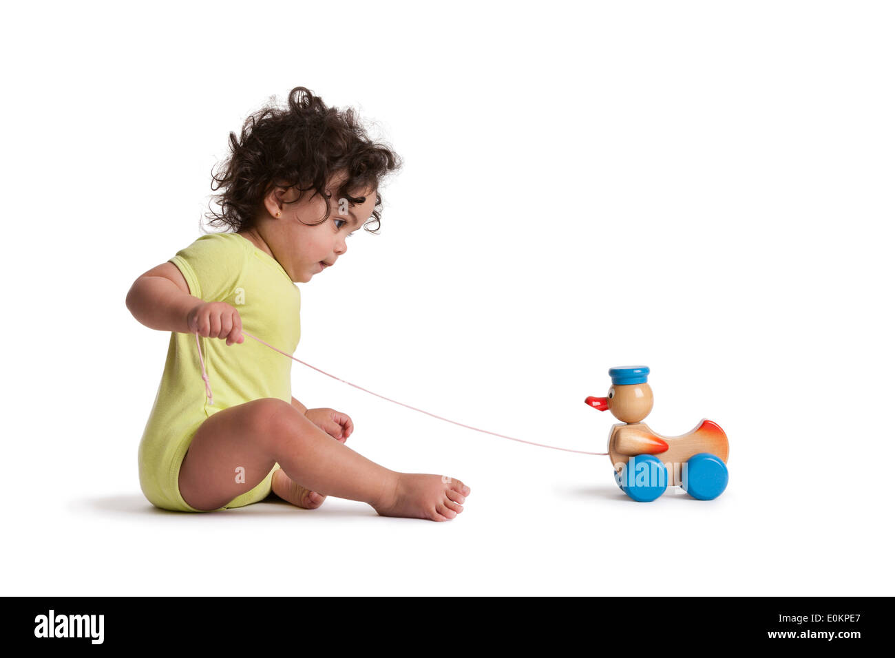 Bébé fille jouant avec un canard sur fond blanc Banque D'Images