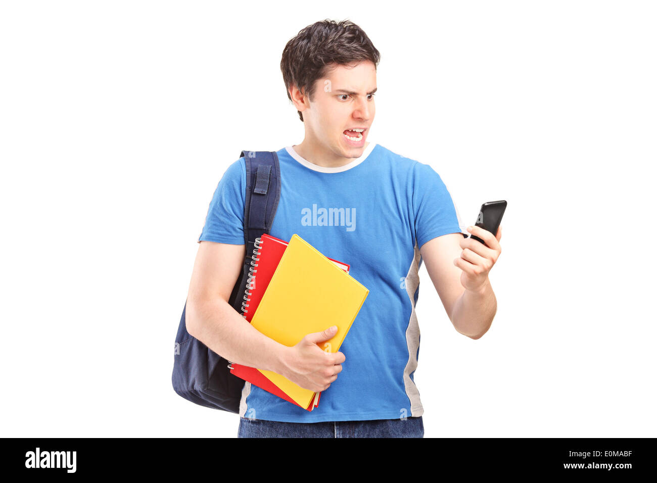 Furious student looking at a cell phone Banque D'Images