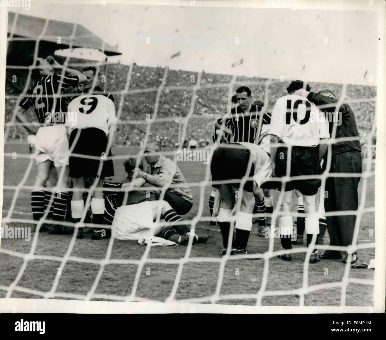 Mai 05, 1956 - Manchester City gagne la F.A. Finale Coupe battre Birmingham City 3-1. Photo montre les joueurs se rassembler autour du Manchester City goalmouth, comme les premiers soins est donnée à l'allemand, le gardien de Manchester City Bert Trautmann, dans les étapes finales du match - la F.A. Cup à Wembley finale - il s'est blessé au cou comme il a plongé pour la balle. Il a été pendant un temps instable mais n'a pas arrêter de jouer. Manchester City a remporté par 3 buts à 1. Banque D'Images
