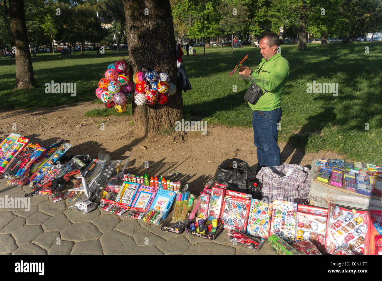L'homme vend des jouets d'enfants, Parc Rinia, Tirana, Albanie Banque D'Images