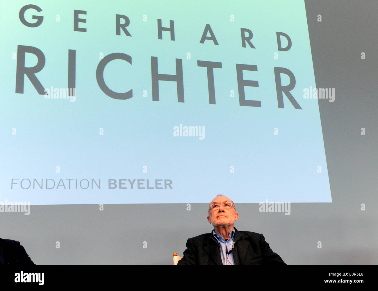 L'artiste allemand Gerhard Richter assis au cours d'une conférence de presse à l'occasion de l'ouverture d'une nouvelle exposition à la Fondation Beyeler à Riehen près de Bâle (Suisse) devant son nom, projetée sur un mur derrière lui, le 16 mai 2014. Banque D'Images