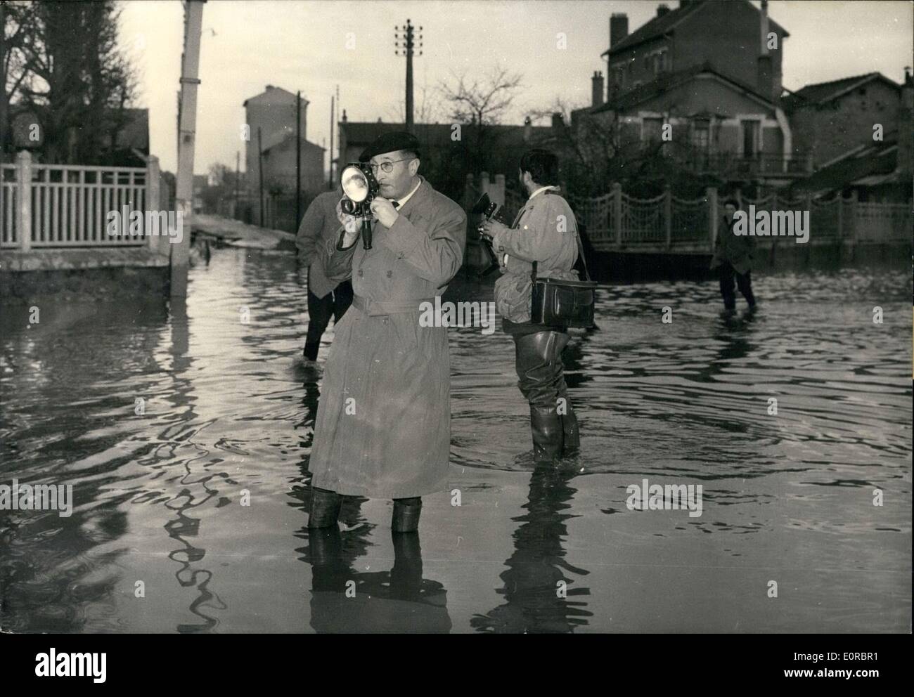 01 janv., 1959 - inondations en banlieue de Paris photographes de presse : porter des bottes sont vu pataugeant dans l'eau dans une zone inondée dans la périphérie de Paris aujourd'hui. Banque D'Images