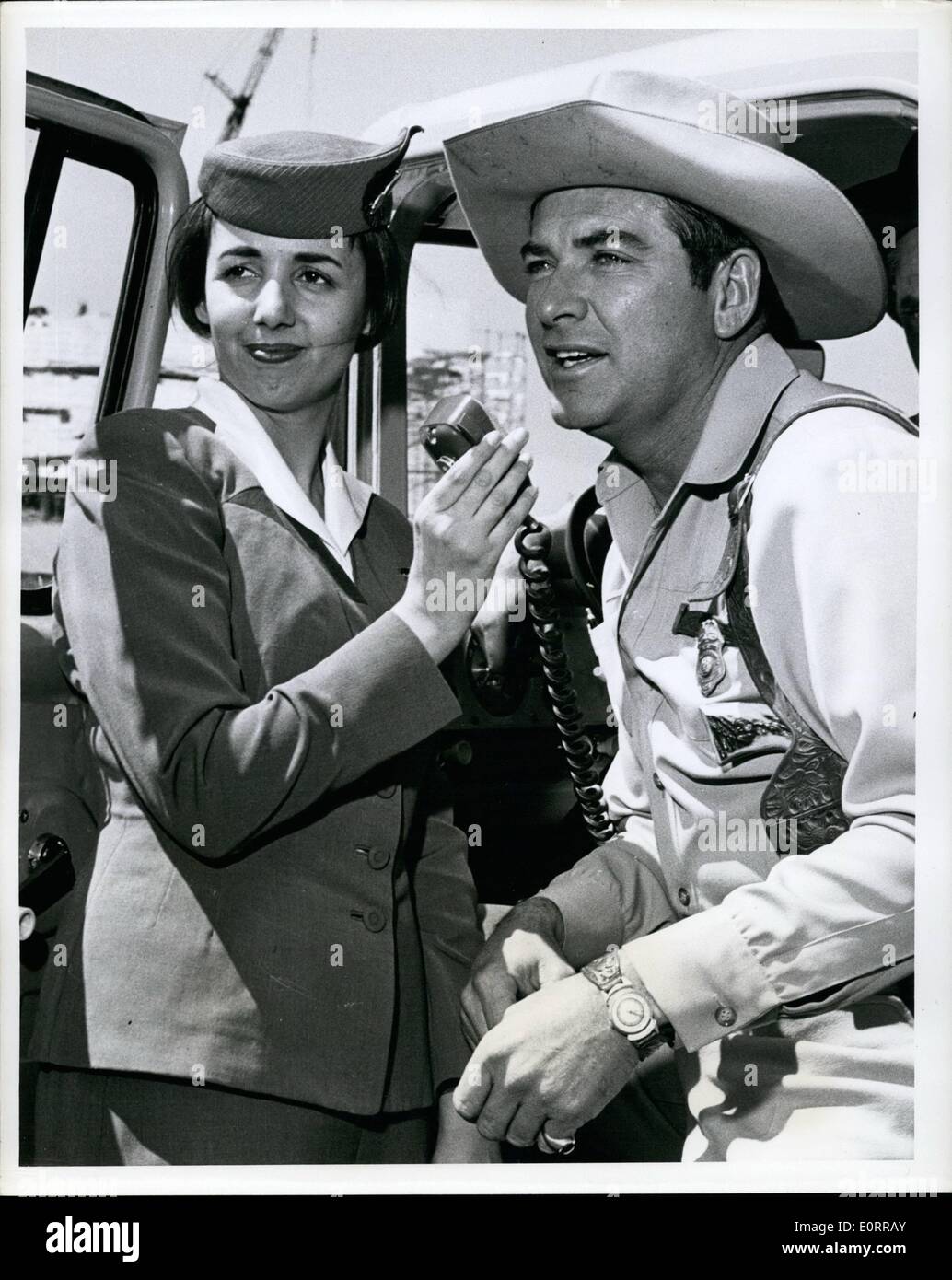 Mai 05, 1960 - L'Aéroport International de New York : John Bromfield TV's ''US Marshal'' prend un appel immédiatement à l'arrivée via la TWA Superjet de Saint-louis alors qu'hôtesse TWA Nan El doit se distingue par Bromfield fera plusieurs apparitions TV & personnelles au cours de sa visite de six jours. Credit : Trans World Airlines Banque D'Images