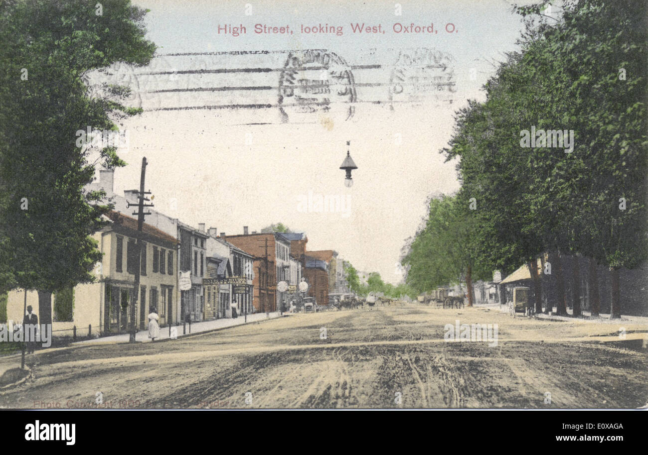 Cette carte postale historique capture une vue de High Street à Oxford, Ohio, vers l'ouest. La zone commerciale animée présente des magasins et des boutiques typiques de la vie urbaine américaine du début du XXe siècle, offrant un aperçu de la croissance urbaine dans la région. Banque D'Images