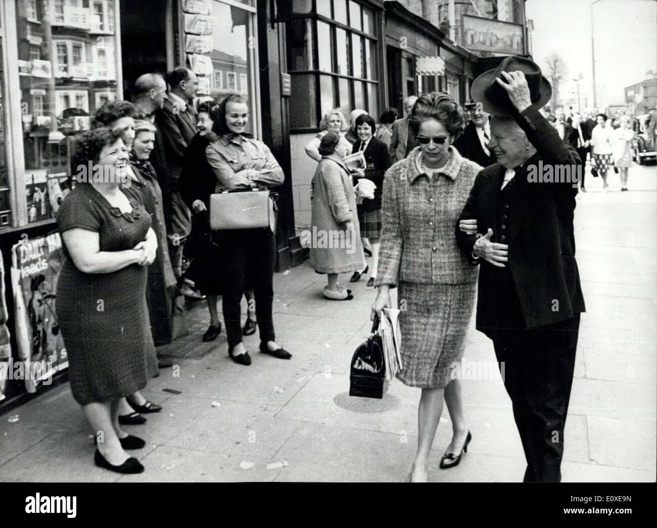 11 mai 1966 - Charlie Chaplin dans le Old Kent Road. Charlie Chaplin a terminé le tournage de son nouveau photo ''Une Comtesse de Hong Kong'' hier - et n'a que seulement une courte distance de la place à Southwark, Londres, où il est né il y a 77 ans. Les scènes finales étaient dans un entrepôt à l'Old Kent Road, à seulement deux détours du Chaplin de naissance à East Street. M. Chaplin n'a pas visiter la rue - il a déjà fait, seul. Photo montre :- Charlie Chaplin, avec son épouse Oona, reconnaissant son welcome in London's Old Kent Road hier. Banque D'Images
