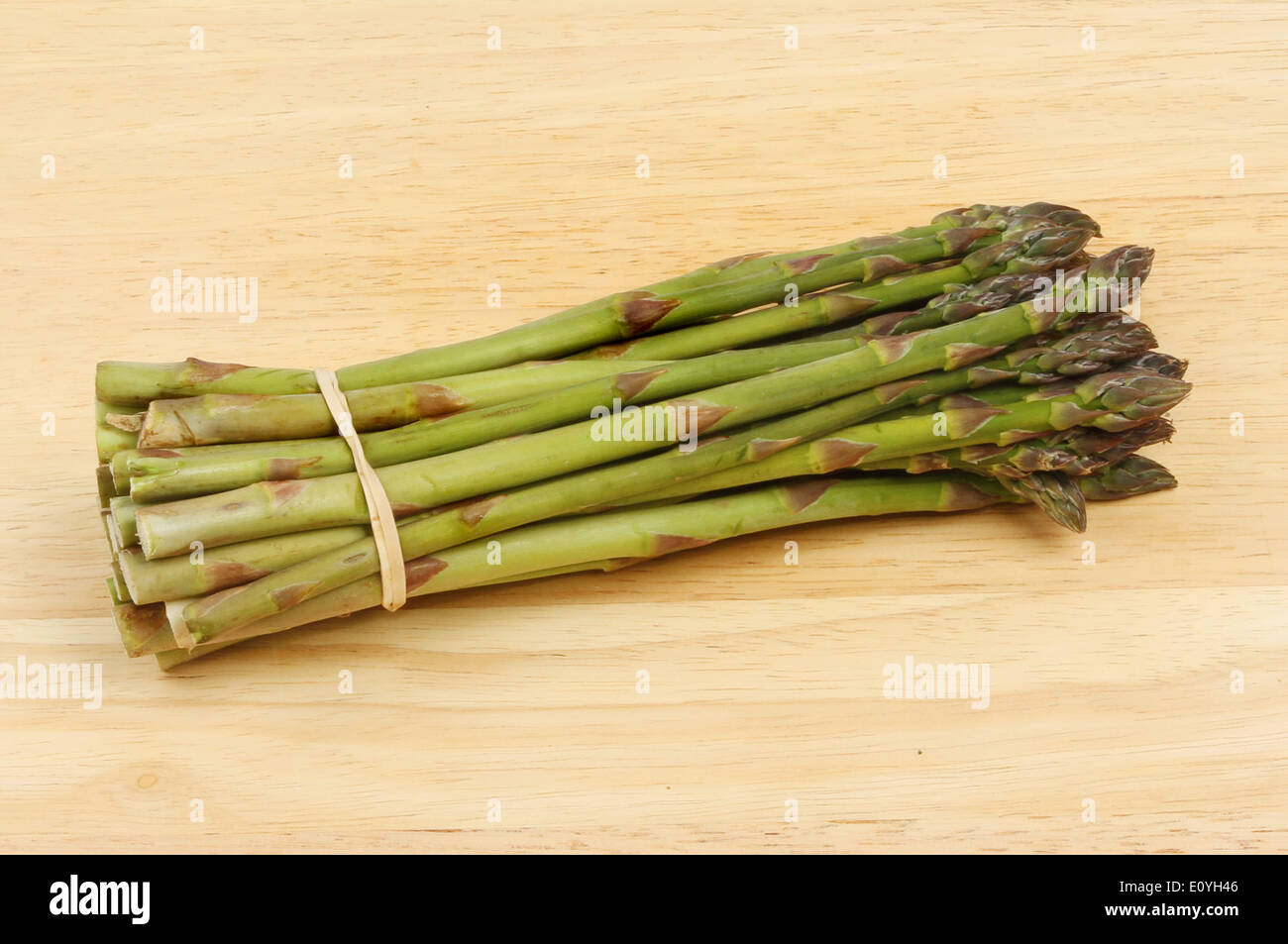 Bande d'asperges fraîches sur une planche en bois Banque D'Images