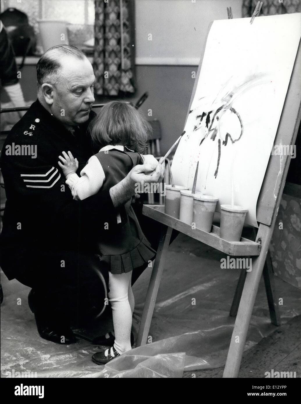 Le 26 février 2012 - aider une petite fille avec sa peinture a quelque chose qui cloche mais Sergent Stibbards connaît toutes les réponses et la petite fille est rassuré. Banque D'Images