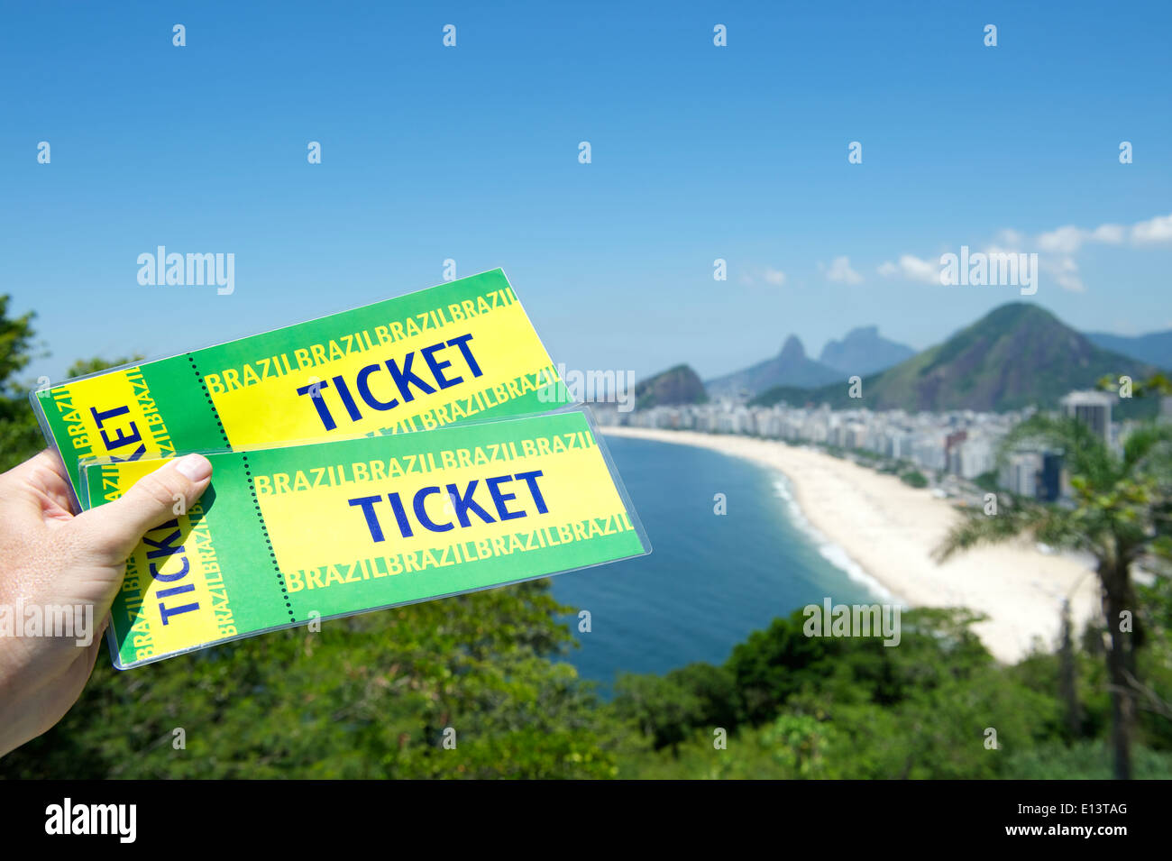 Main tenant deux billets au-dessus de la plage brésilienne de Copacabana à Rio de Janeiro Banque D'Images
