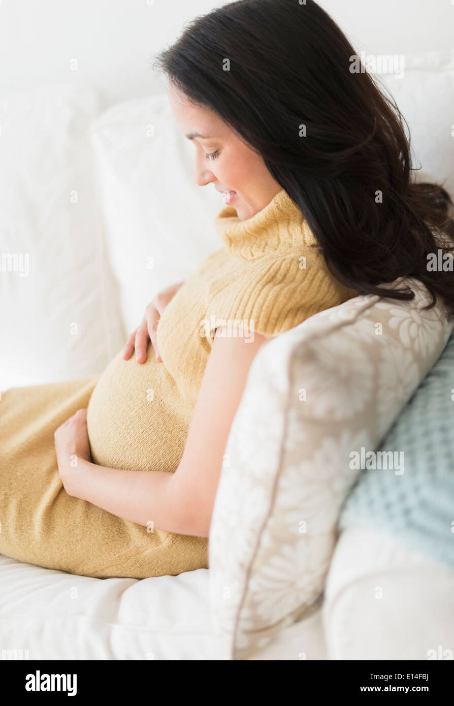 Pregnant Hispanic woman holding her belly Banque D'Images