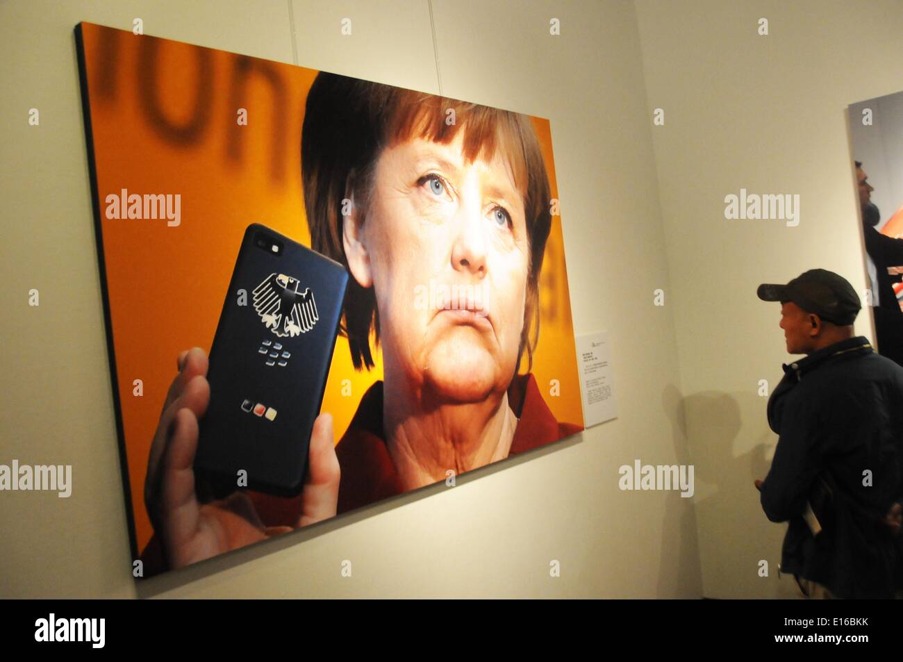 Beijing, Chine. 24 mai, 2014. Une personne affiche la photo 'Angela Merkel et son portable' à la 10e China International Press Photo Contest (CHIPP) Exposition photos gagnantes à Beijing, capitale de Chine, le 24 mai 2014. L'exposition, l'affichage de 229 photos gagnantes, a débuté à la Chine Monument du millénaire le samedi. © Wang Zhen/Xinhua/Alamy Live News Banque D'Images