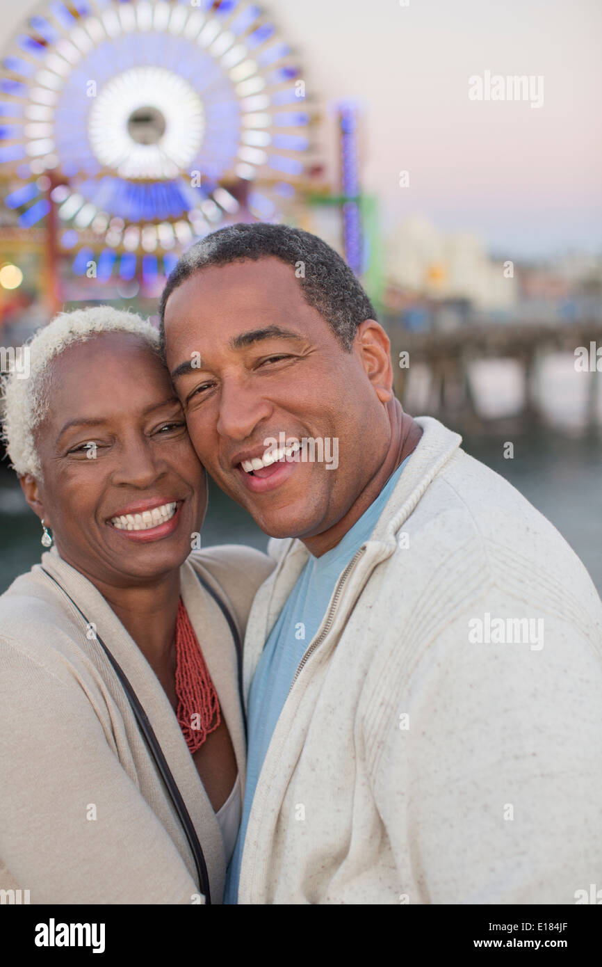 Portrait of happy senior couple at amusement park Banque D'Images