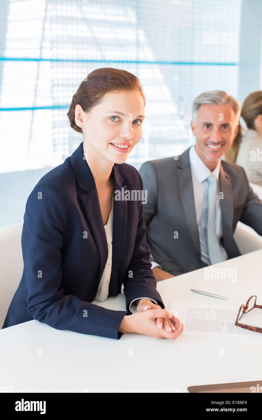 Portrait of business people at conference table Banque D'Images