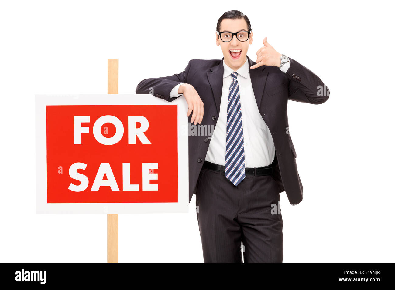 Homme debout par un agent immobilier à vendre sign Banque D'Images