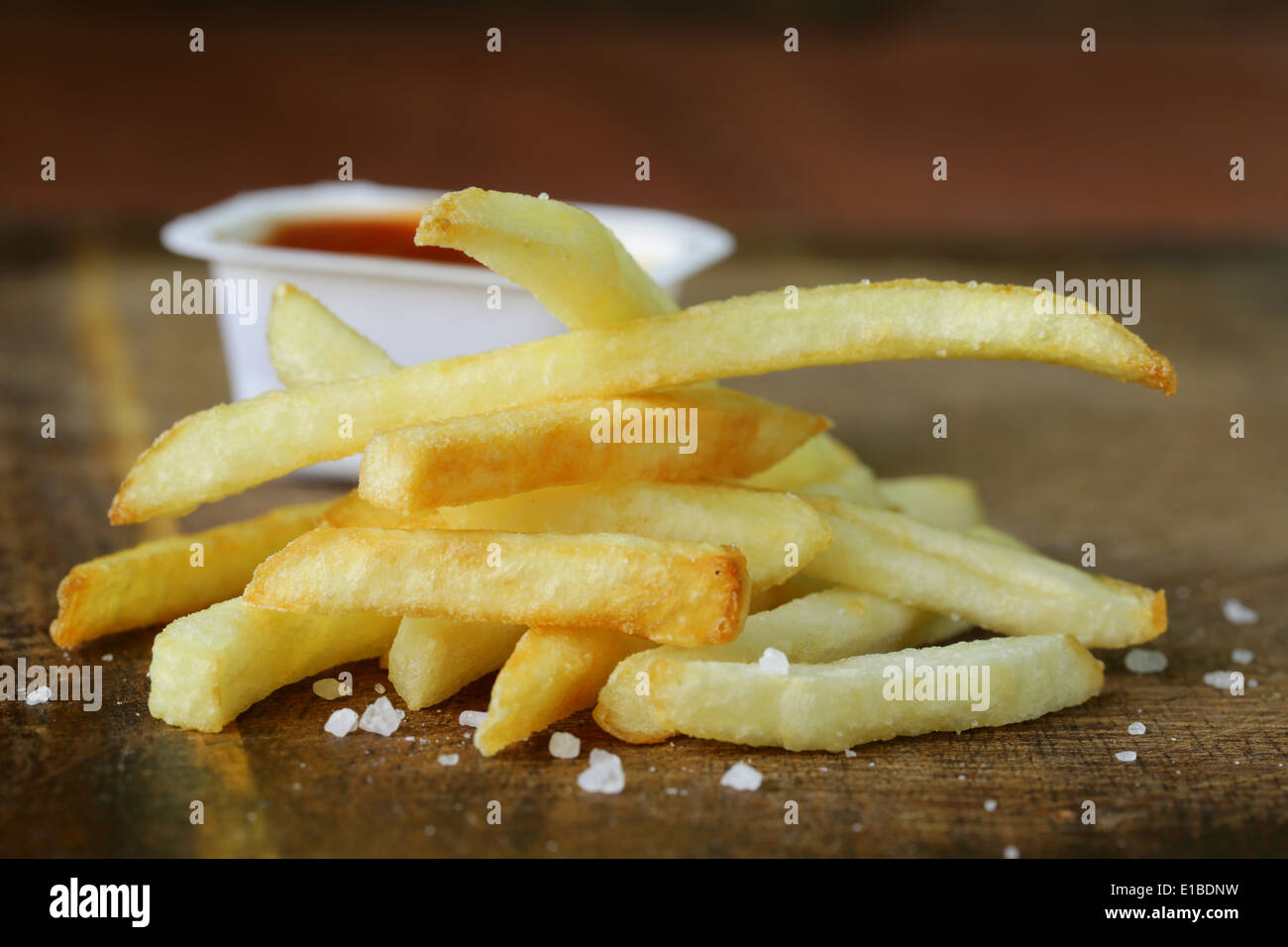 Pommes frites traditionnelles avec du sel sur fond de bois Banque D'Images