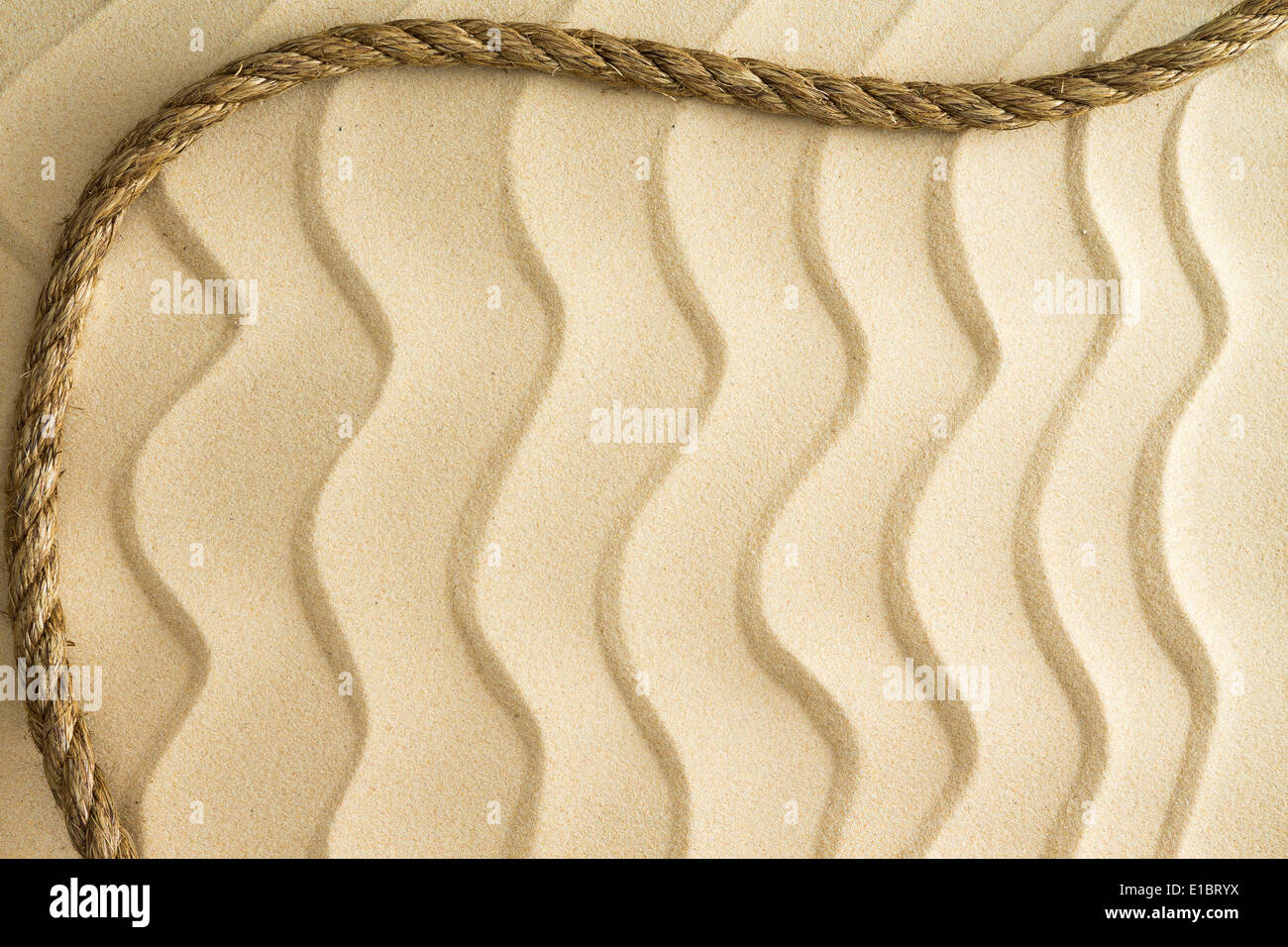 Arrière-plan de nautique ondée de sable de plage dorée avec un effet décoratif avec une corde en courbe frontière et copy space Banque D'Images
