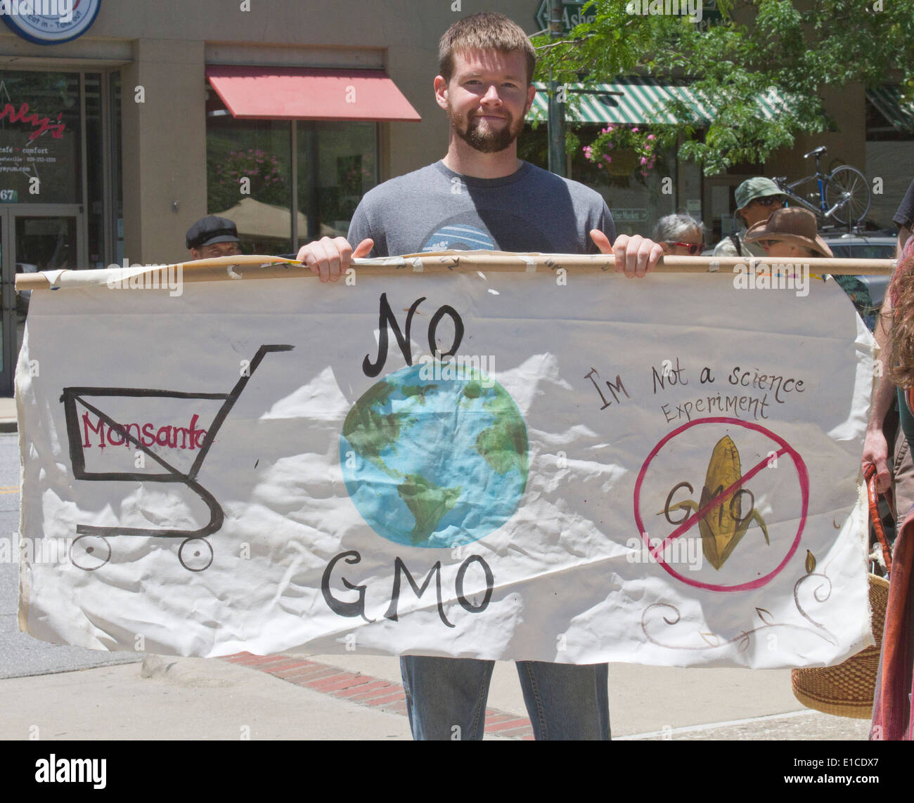 Asheville, NC, USA - Le 24 mai 2014 : Jeune homme est titulaire d'un signe qui protestent contre les OGM et Monanto Banque D'Images