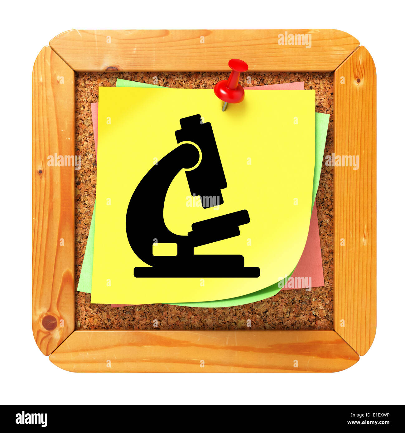L'icône de microscope à autocollant jaune sur le liège Message Board. Banque D'Images