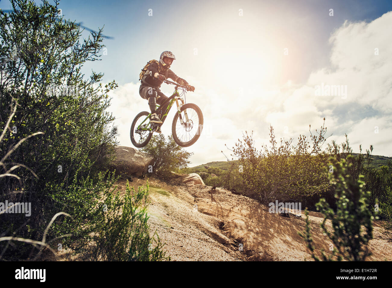 Downhill mountain biker jumping Banque D'Images