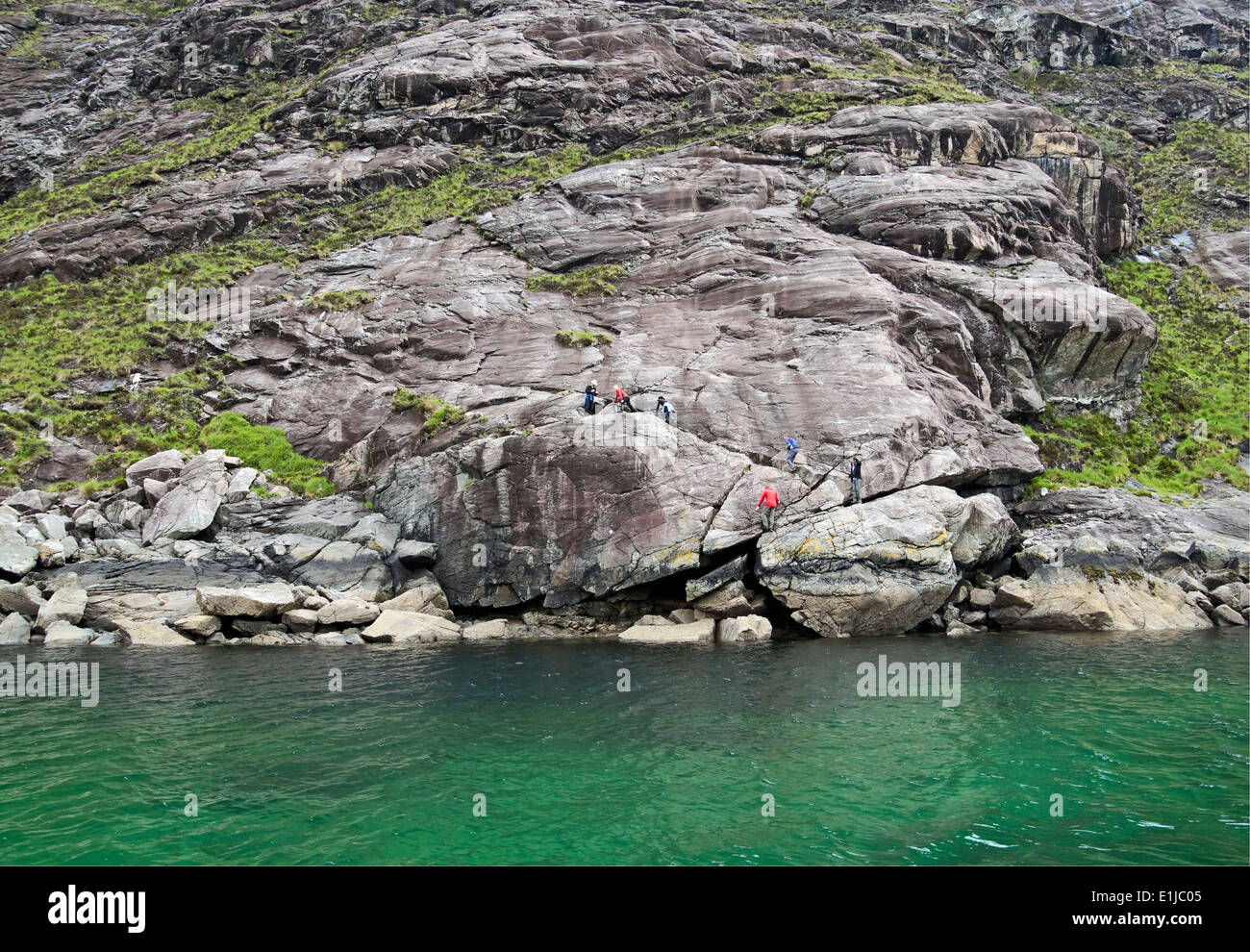Groupe de marcheurs passant sur la mauvaise étape à Loch Scavaig Île de Skye Highland Ecosse Banque D'Images