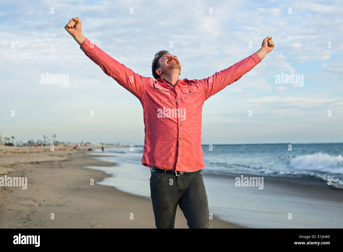 Jeune homme célébrer sur Beach, Long Beach, Californie, USA Banque D'Images