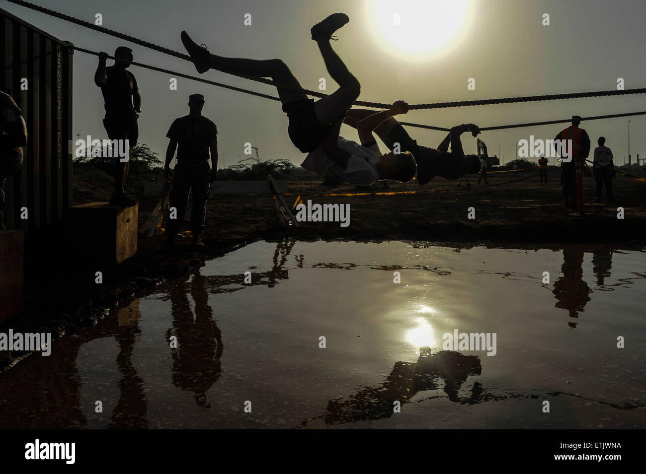Les concurrents utilisent des cordes pour traverser un puits au cours de la Mud Run 5K au Camp Lemonnier, Djibouti, le 28 septembre 2013. (DoD photo de Mas Banque D'Images