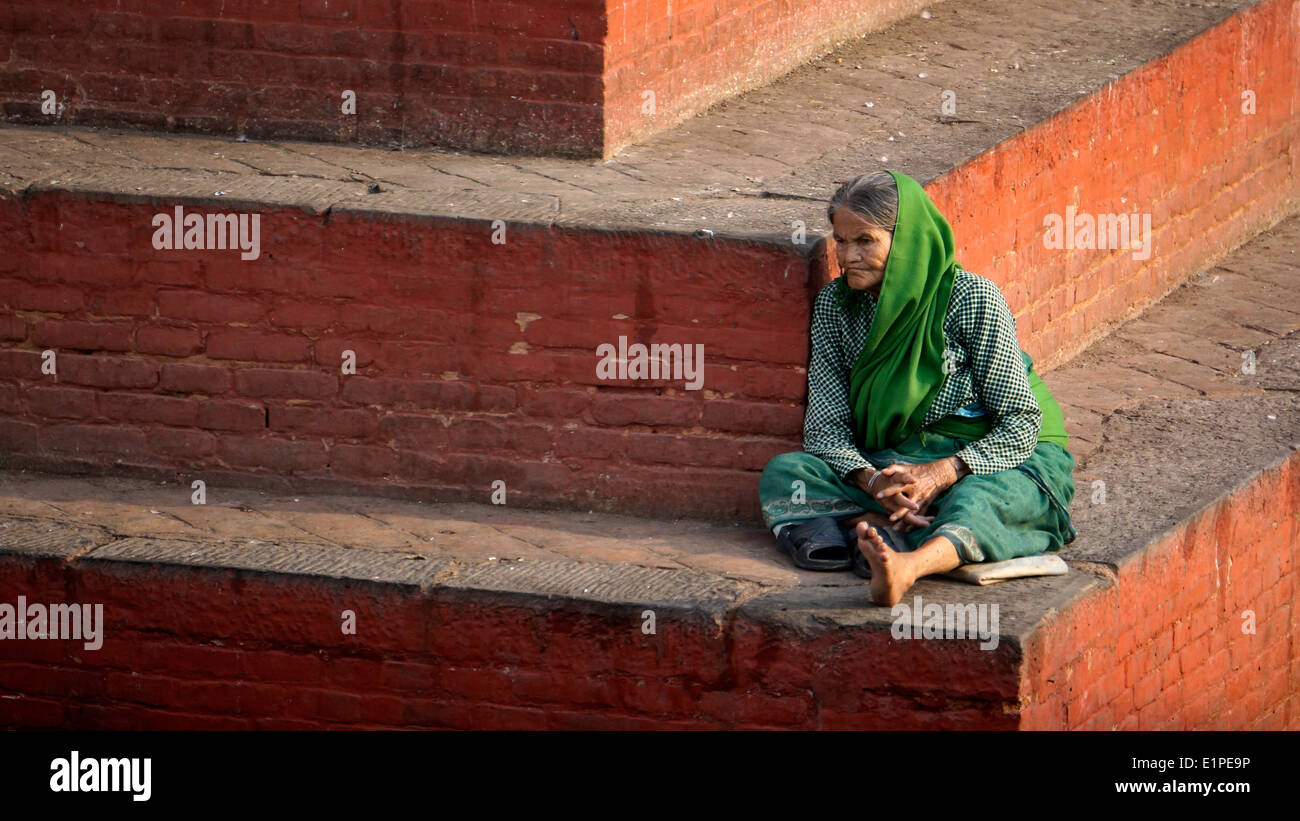 Vieille Femme assise sur l'étape à Durbar Square, Népal, Asie,vie des personnes âgées, Banque D'Images