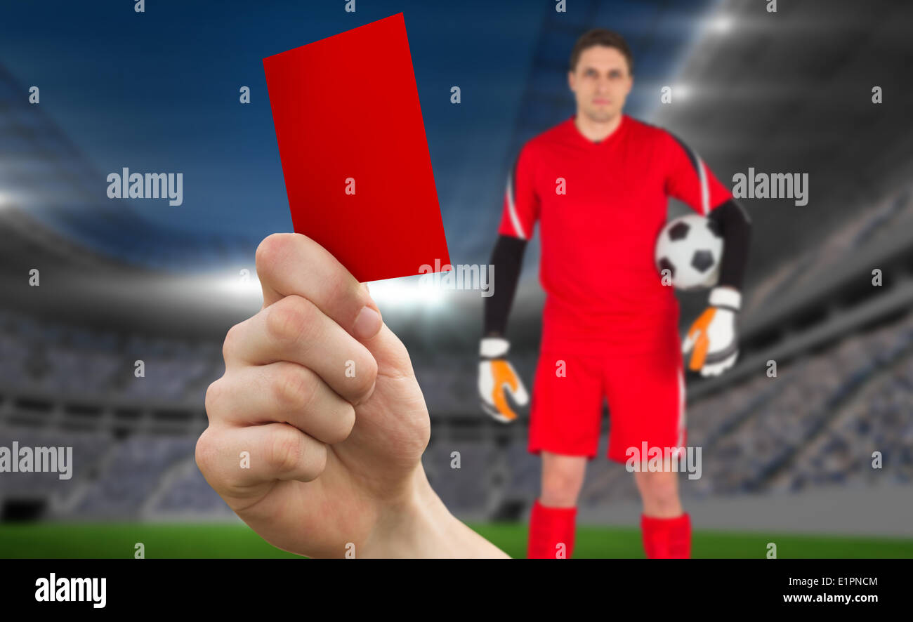 Image composite de hand holding up carton rouge pour le gardien de but  Photo Stock - Alamy