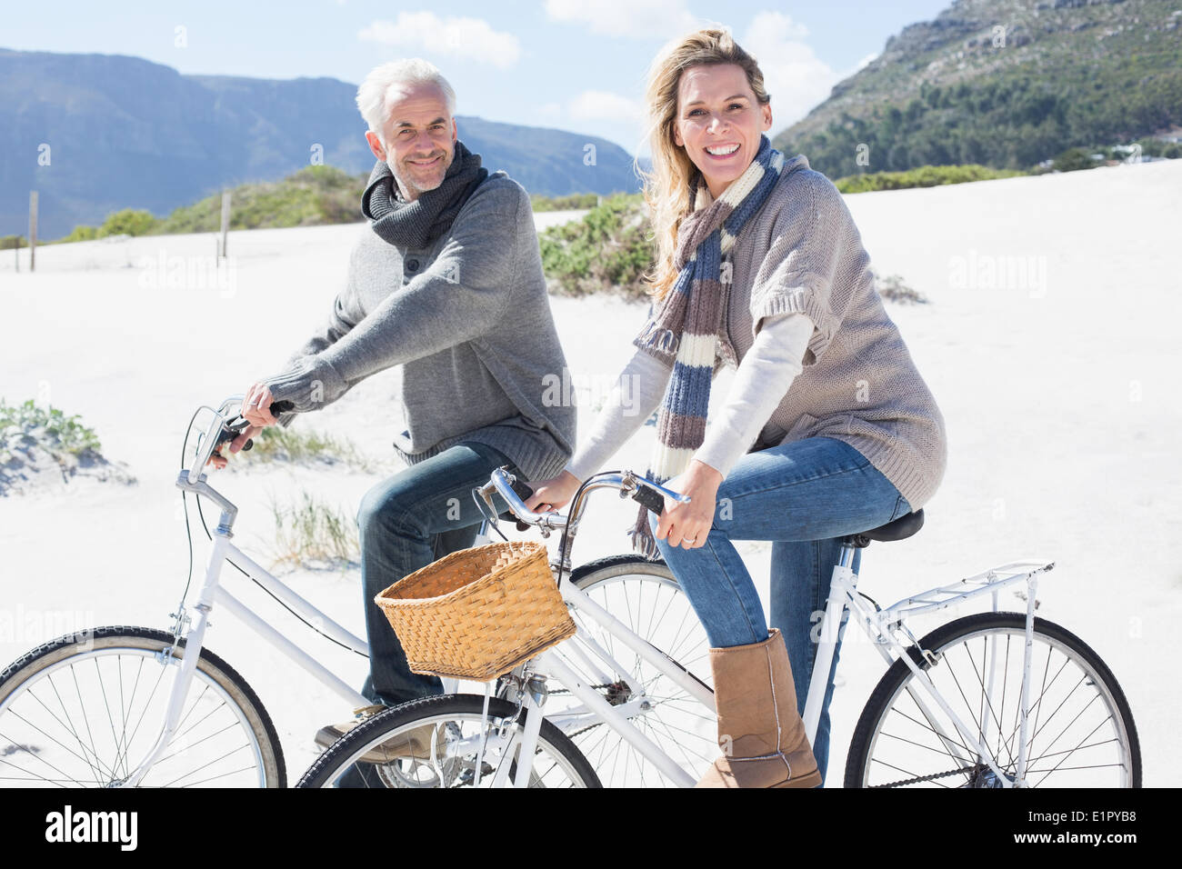 Carefree couple partir en promenade en vélo sur la plage smiling at camera Banque D'Images