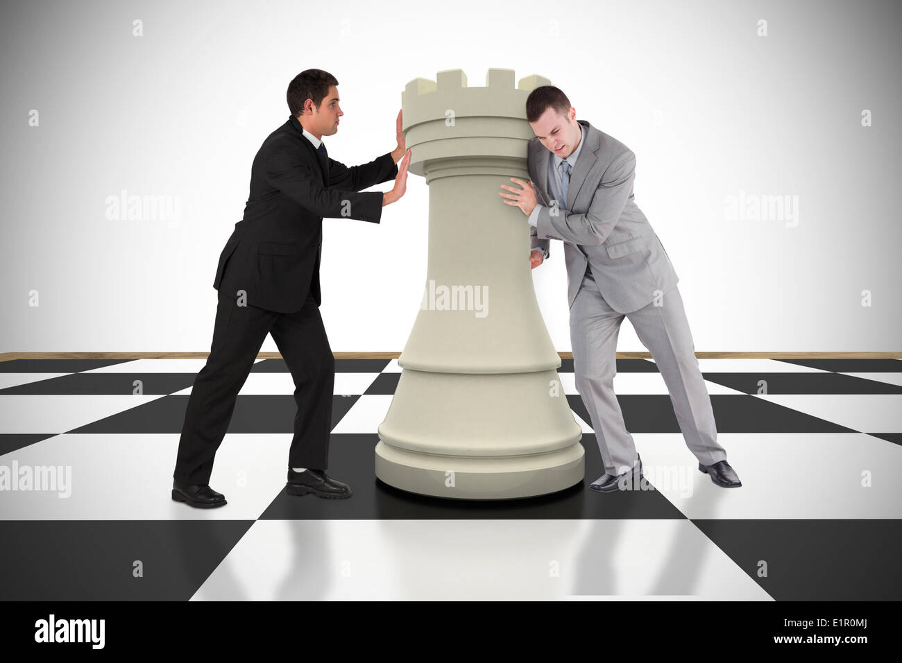 Image composite des gens d'affaires poussant chess piece Banque D'Images