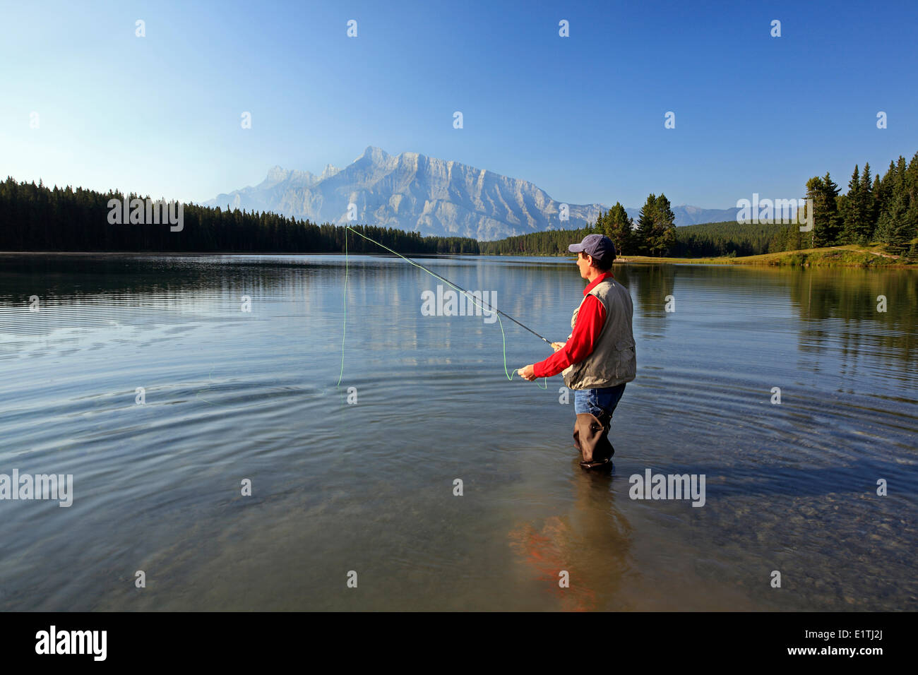 L'âge moyen des hommes de mouche au lac de montagne. Le lac Two Jack avec Rundle Mountain contexte Banff National Park Alberta Canada. Banque D'Images