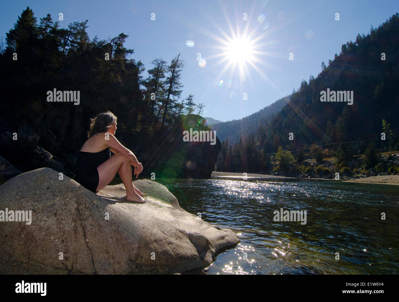 Femme absorbe les rayons de soleil à partir du milieu de la rivière Similkameen à Bromley Rock Provincial Park, British Columbia, Canada Banque D'Images