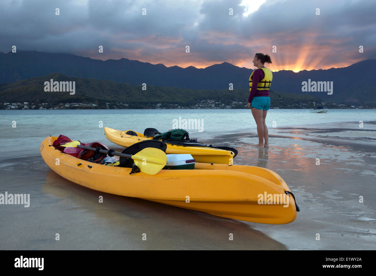 La kayakiste sur le sable en contrebas au coucher du soleil, la baie de Kane'ohe, Oahu, Hawaii, United States of America Banque D'Images